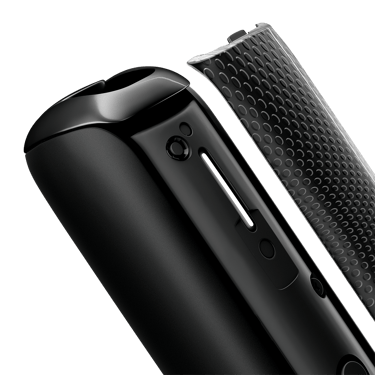 Close-up of Jet Black Augmented Pattern Ploom AURA front panel detached from the device, revealing textured pattern details and bold dark tones