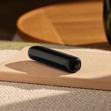 Ploom AURA Jet Black presented as a discreet heated tobacco device designed to fit seamlessly into daily routines.