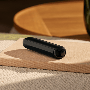 Ploom AURA Jet Black presented as a discreet heated tobacco device designed to fit seamlessly into daily routines.