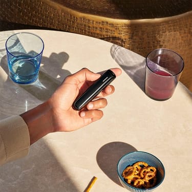 Ploom AURA Jet Black shown as a sleek, convenient heated tobacco device designed for easy handling and everyday use.