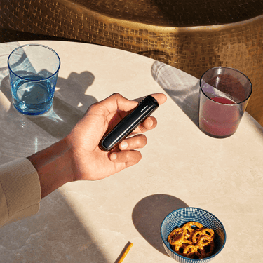 Ploom AURA Jet Black shown as a sleek, convenient heated tobacco device designed for easy handling and everyday use.