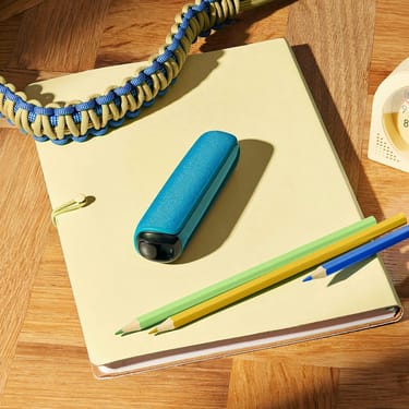Peranti Ploom dengan penutup belakang Ocean Blue di atas buku nota, menambah aksen tenang untuk sesi belajar, bekerja atau berkarya.
