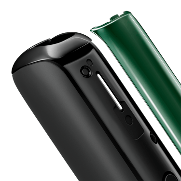 Close-up of Amazon Green Ploom AURA front panel removed, showing glossy texture, vibrant color depth, subtle reflections, and tactile premium feel.
