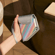 Tangan memegang Multicolored Patterned Canvas Duo Carry Case, menampilkan corak berwarna dan rupa kreatif bertenaga.