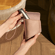 Hand taking a Ploom AURA device out of the Rose Gold Duo Carry Case, demonstrating smooth access and an intuitive, everyday carrying experience.