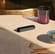 Ploom AURA Jet Black resting on a table, styled as a discreet companion with modern design and minimal visual presence.