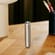 Ploom AURA Lunar Silver device shown standing upright, highlighting stability, balance, and discreet heated tobacco design.

